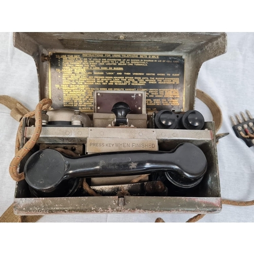 7 - 1938 dated combination British military field telephone, Morse key and headset.