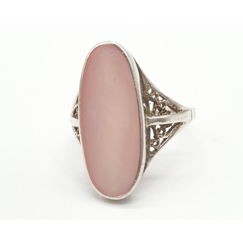 846 - Silver ring having large pink stone to top. Attractive Filigree work to shoulders. Size N1/2 .