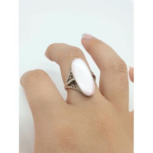 846 - Silver ring having large pink stone to top. Attractive Filigree work to shoulders. Size N1/2 .