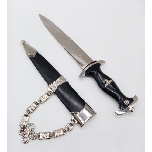 316 - An interesting reproduction Nazi dagger with chain attached to its scabbard. German inscription on b... 