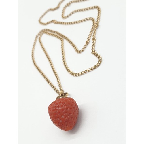 537 - Strawberry pendant set on yellow metal chain, weight 3.7g and 49cm long approx