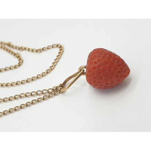 537 - Strawberry pendant set on yellow metal chain, weight 3.7g and 49cm long approx