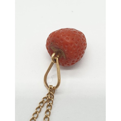 537 - Strawberry pendant set on yellow metal chain, weight 3.7g and 49cm long approx