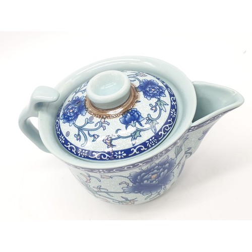 148 - A Chinese white porcelain with blue Paeonies tea set consisting of six cups and a lidded tea pot in ... 