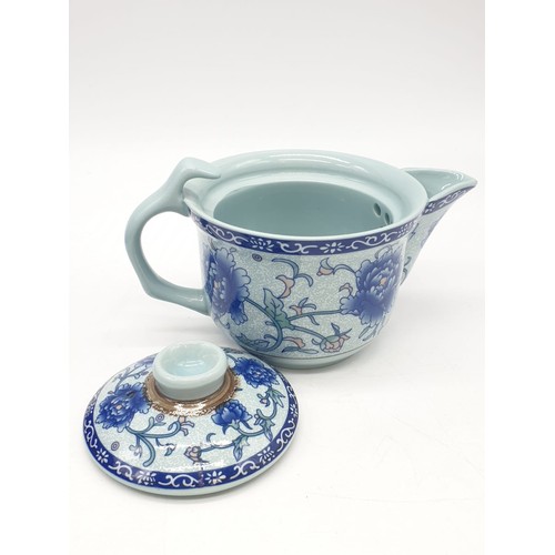 148 - A Chinese white porcelain with blue Paeonies tea set consisting of six cups and a lidded tea pot in ... 