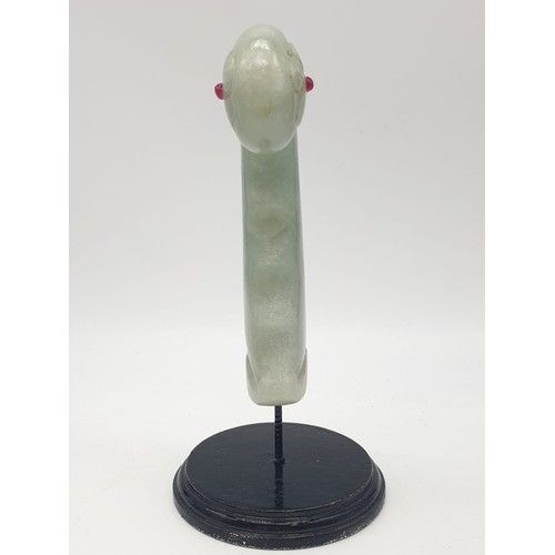 57 - A Mughal, light green, carved jade hilt with two red stones (ruby?) on a custom made base. India 18t... 