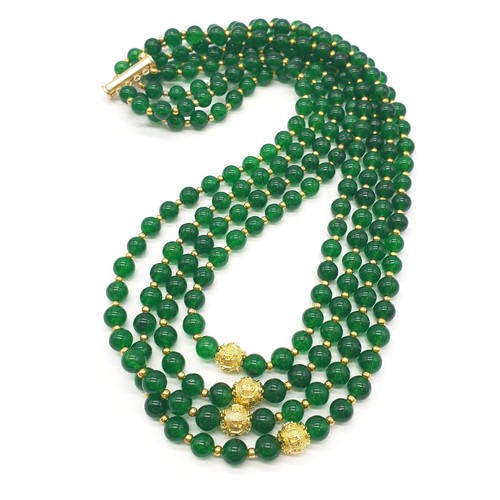 183 - A four row green jade necklace with Chinese gilded central beads and assorted Earrings. Necklace len... 