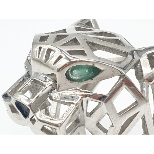 36 - A sterling silver Cartier Panther style lattice ring with emerald eyes. Ring Size: N, weight  19.5g.