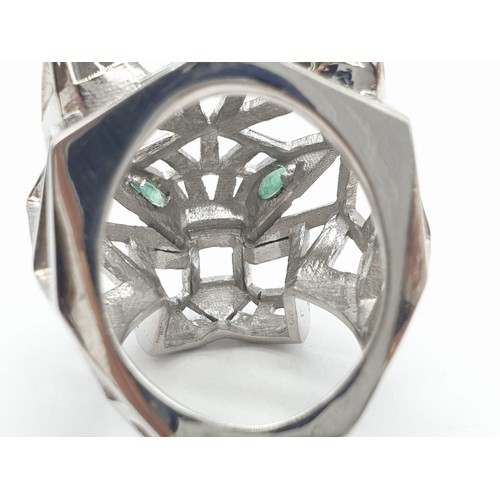 36 - A sterling silver Cartier Panther style lattice ring with emerald eyes. Ring Size: N, weight  19.5g.