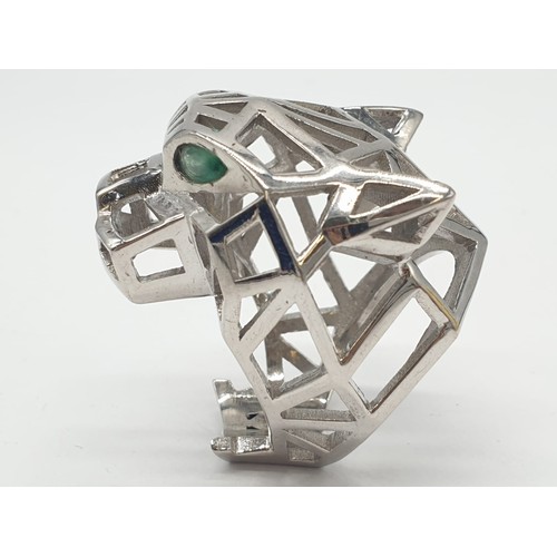 36 - A sterling silver Cartier Panther style lattice ring with emerald eyes. Ring Size: N, weight  19.5g.