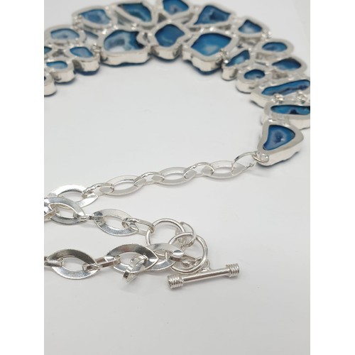 92 - A necklace, bracelet and ring set with blue agate from Botswana, in a presentation case. Necklace le... 
