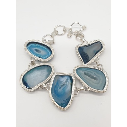 92 - A necklace, bracelet and ring set with blue agate from Botswana, in a presentation case. Necklace le... 