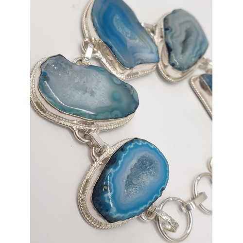 92 - A necklace, bracelet and ring set with blue agate from Botswana, in a presentation case. Necklace le... 