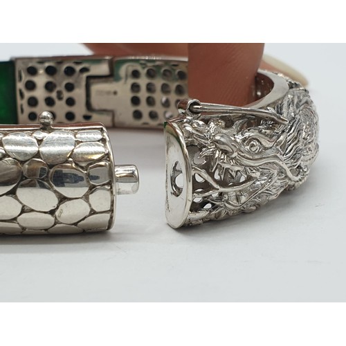 85 - A beautiful Chinese hand carved jade and sterling silver bracelet with engraved dragons. Internal di... 