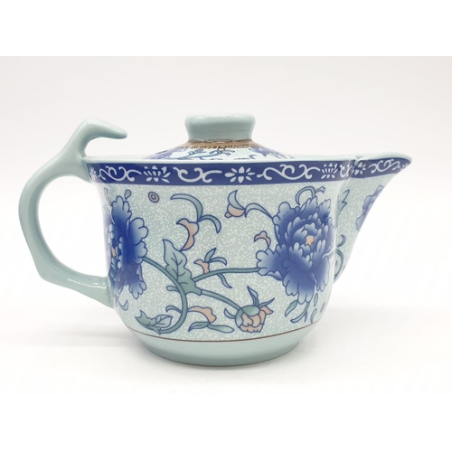 148 - A Chinese white porcelain with blue Paeonies tea set consisting of six cups and a lidded tea pot in ... 