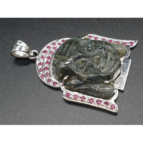 178 - 925 silver Pendant inset with a Labradorite Buddha shaped stone, and surrounded by Rubies on the per... 