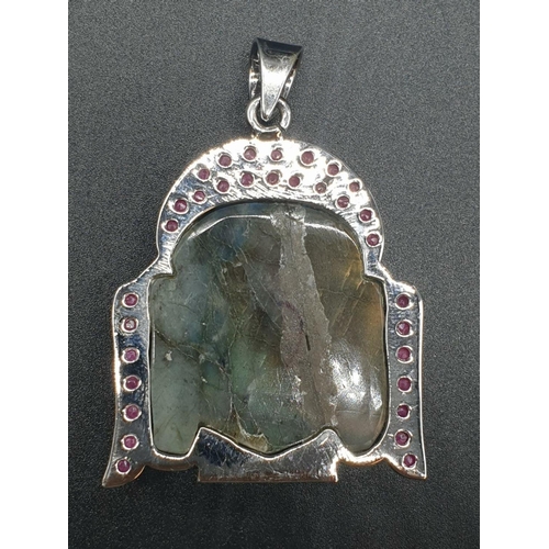 178 - 925 silver Pendant inset with a Labradorite Buddha shaped stone, and surrounded by Rubies on the per... 