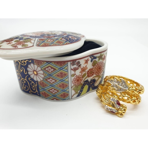 190 - A Chinese, hand painted with exquisite detail, porcelain trinket box revealing an elaborate Chinese ... 