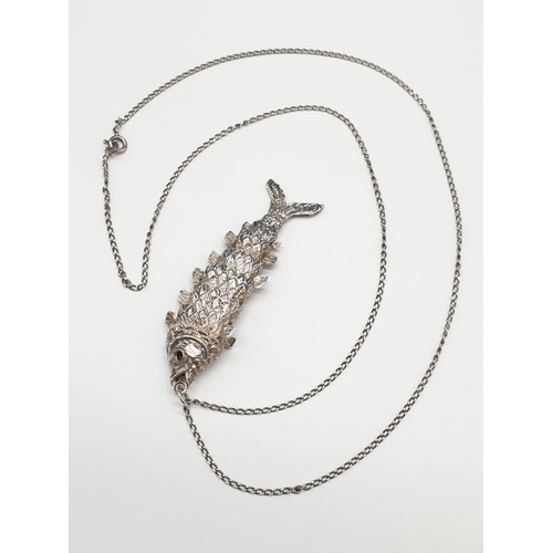 203 - Silver articulated fish pendant on silver chain. Hallmarked 1977. Length of pendant 6.5cm. Chain len... 