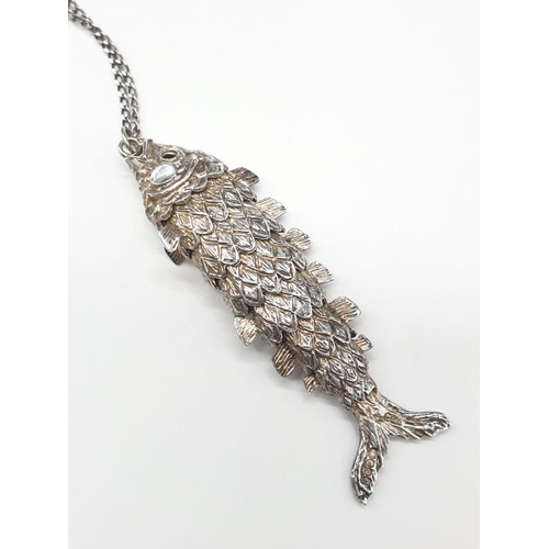 203 - Silver articulated fish pendant on silver chain. Hallmarked 1977. Length of pendant 6.5cm. Chain len... 