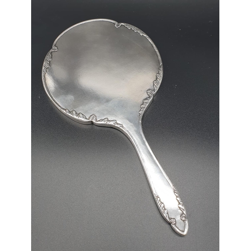 209 - Silver Zeesung 1900 Chinese hand mirror, hand chased with bevelled glass. 30 cm in length.