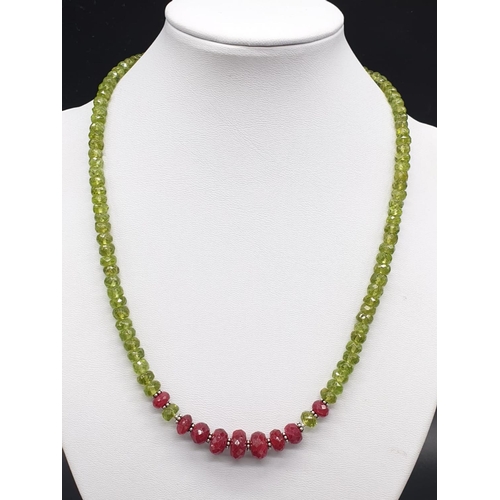 242 - 6mm-9mm Peridot Necklace With Rubies and Silver Findings, 18 inches length. Weight 31 grams.