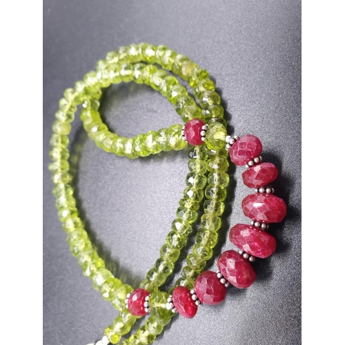 242 - 6mm-9mm Peridot Necklace With Rubies and Silver Findings, 18 inches length. Weight 31 grams.