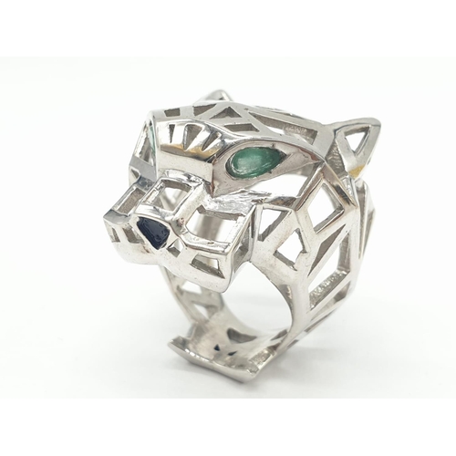 36 - A sterling silver Cartier Panther style lattice ring with emerald eyes. Ring Size: N, weight  19.5g.