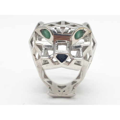 36 - A sterling silver Cartier Panther style lattice ring with emerald eyes. Ring Size: N, weight  19.5g.