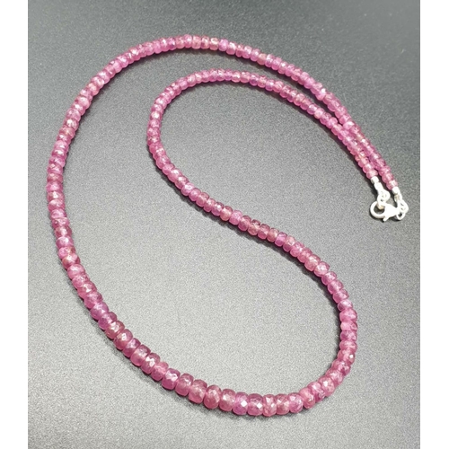 425 - A single row ruby necklace with sterling silver clasp. Length 22cm, weight 19.25 grams.