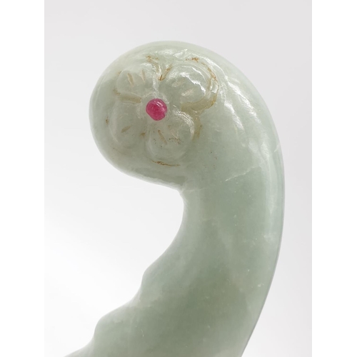 57 - A Mughal, light green, carved jade hilt with two red stones (ruby?) on a custom made base. India 18t... 