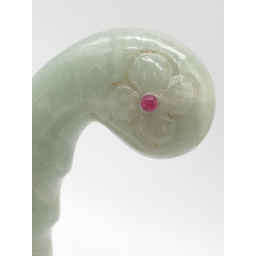 57 - A Mughal, light green, carved jade hilt with two red stones (ruby?) on a custom made base. India 18t... 