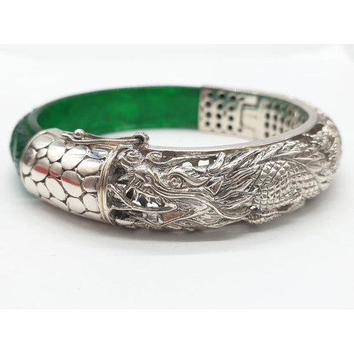 85 - A beautiful Chinese hand carved jade and sterling silver bracelet with engraved dragons. Internal di... 