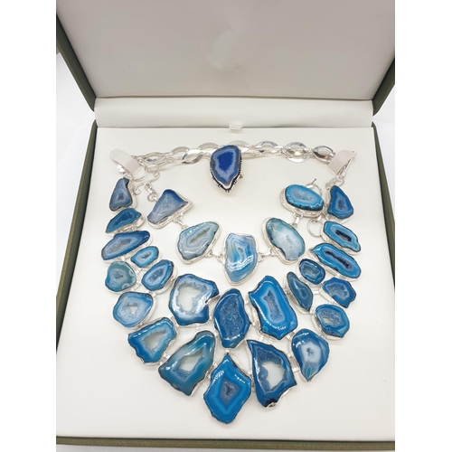 92 - A necklace, bracelet and ring set with blue agate from Botswana, in a presentation case. Necklace le... 