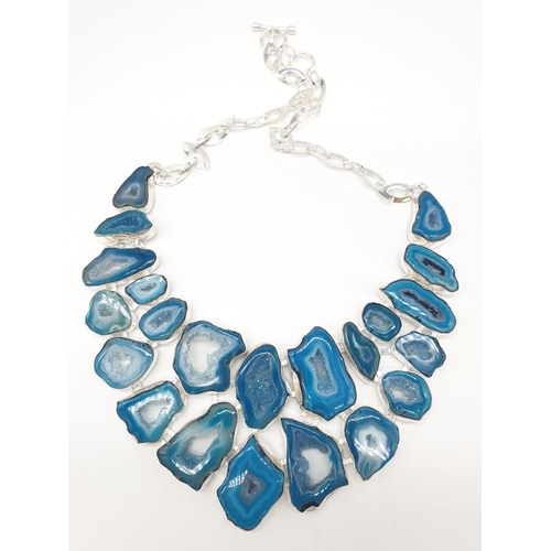 92 - A necklace, bracelet and ring set with blue agate from Botswana, in a presentation case. Necklace le... 