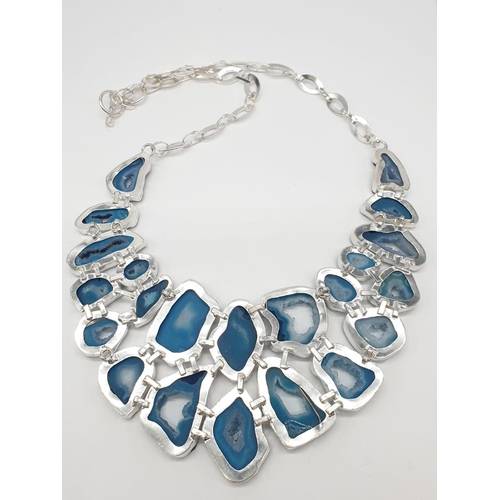 92 - A necklace, bracelet and ring set with blue agate from Botswana, in a presentation case. Necklace le... 