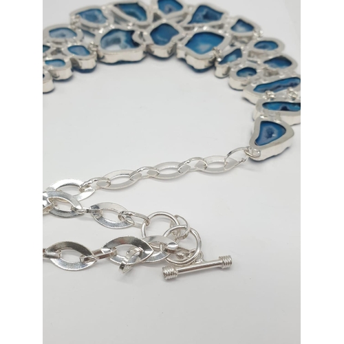 92 - A necklace, bracelet and ring set with blue agate from Botswana, in a presentation case. Necklace le... 