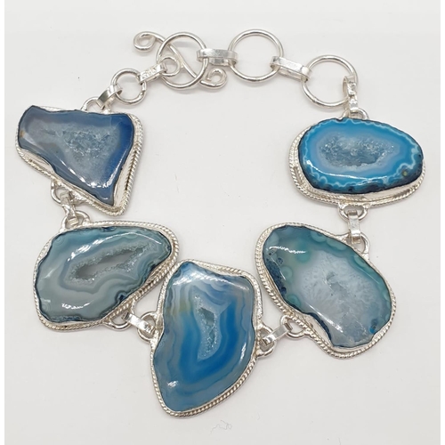 92 - A necklace, bracelet and ring set with blue agate from Botswana, in a presentation case. Necklace le... 
