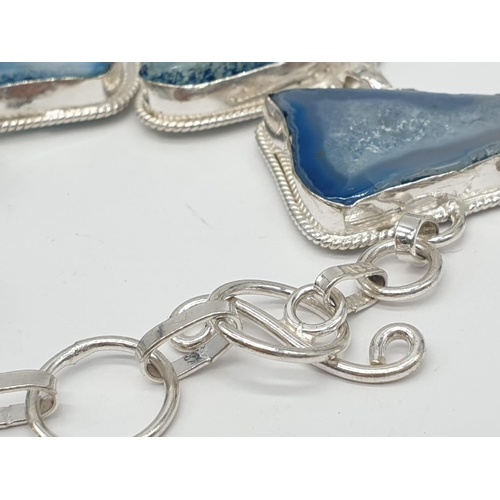 92 - A necklace, bracelet and ring set with blue agate from Botswana, in a presentation case. Necklace le... 