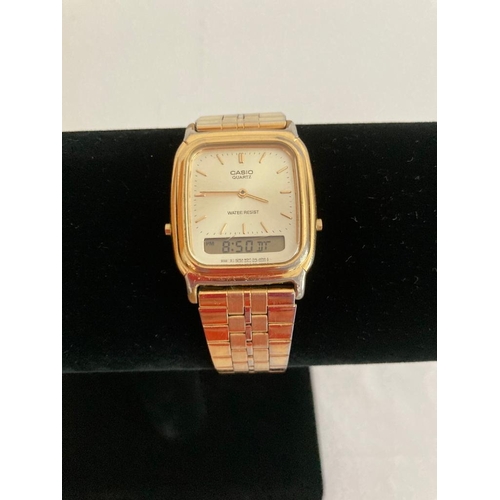 467 - Vintage Casio AQ307 gents wristwatch. Gold tone with metal strap. Working order.