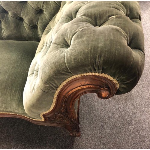 114 - A Victorian chaise lounge with plush green velvet restoration, deep buttons and a beautiful carved w... 