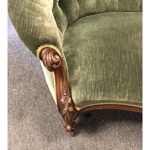 114 - A Victorian chaise lounge with plush green velvet restoration, deep buttons and a beautiful carved w... 