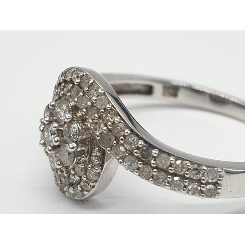 173 - 9ct white gold diamond twist cluster ring, 0.50ct diamond approx, weight 2.5g and size P