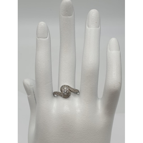 173 - 9ct white gold diamond twist cluster ring, 0.50ct diamond approx, weight 2.5g and size P