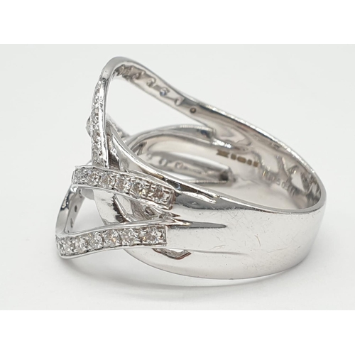 238 - An 18ct white gold diamond encrusted modern ring. 8.4g in weight and size N.