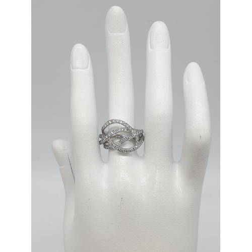 238 - An 18ct white gold diamond encrusted modern ring. 8.4g in weight and size N.