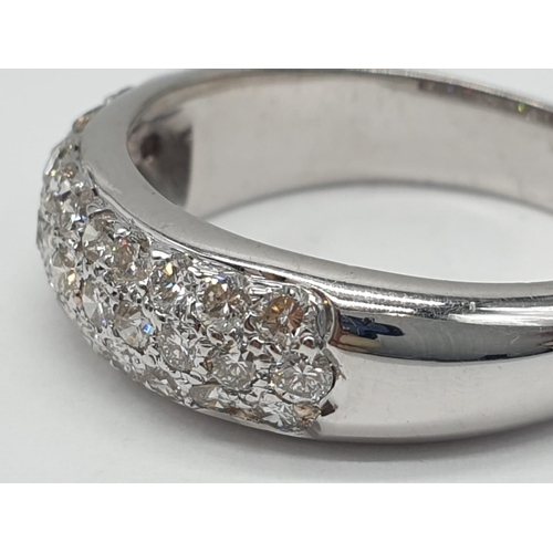 304 - A diamond encrusted 18ct white gold ring. 6.4g and size N.