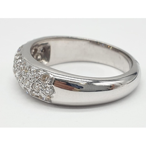 304 - A diamond encrusted 18ct white gold ring. 6.4g and size N.