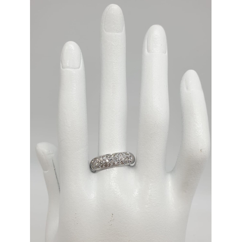 304 - A diamond encrusted 18ct white gold ring. 6.4g and size N.