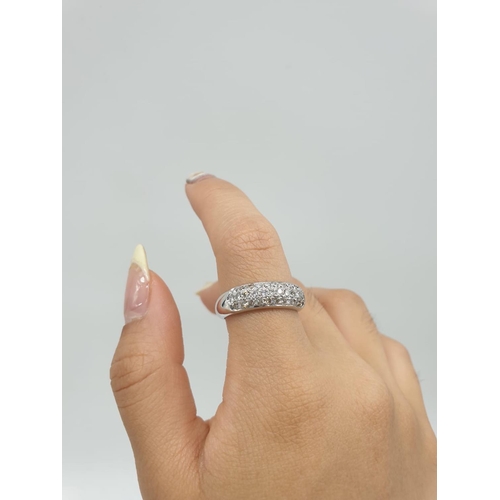 304 - A diamond encrusted 18ct white gold ring. 6.4g and size N.